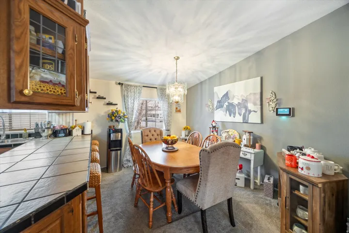 Dining room with a chandelier and dark carpet
