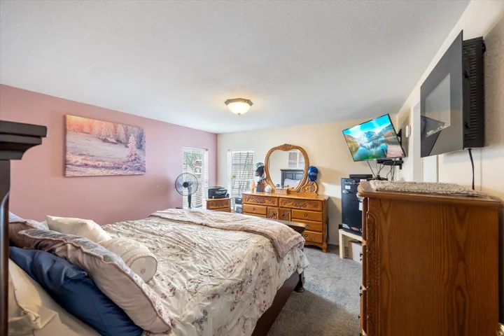 Bedroom with carpet floors and a textured ceiling