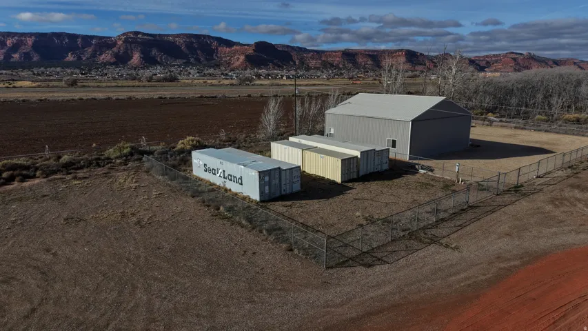 Large shop is not on parcel and is not for sale. Property is the vacant lot - cargo containers not included.