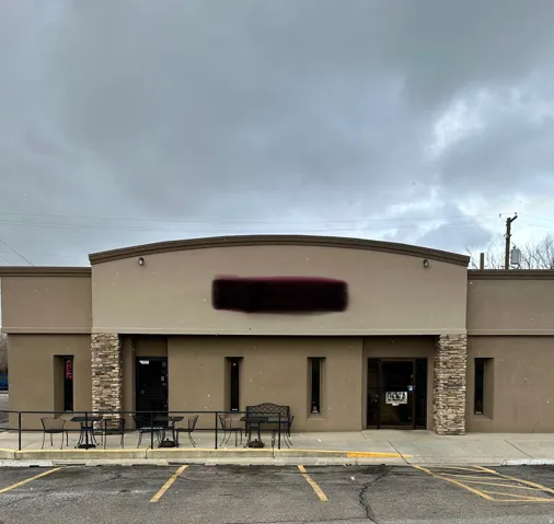 View of building exterior featuring uncovered parking
