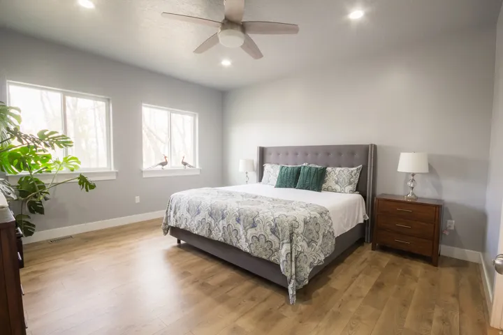 Bedroom with wood finished floors, ceiling fan, and recessed lighting