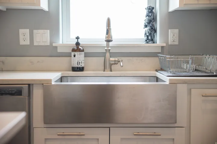 Kitchen view of dishwasher and light countertops