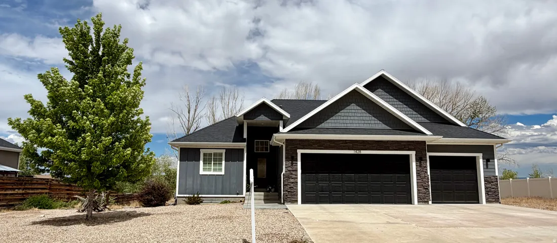 Contemporary exterior with mixed materials including vertical siding, horizontal siding, and stone veneer accents