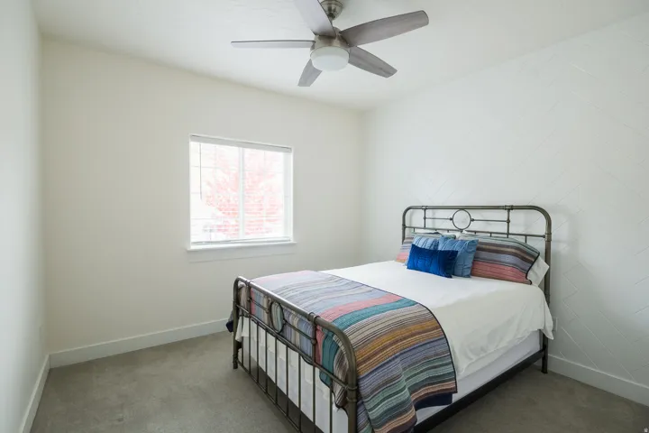 Bedroom featuring carpet and ceiling fan