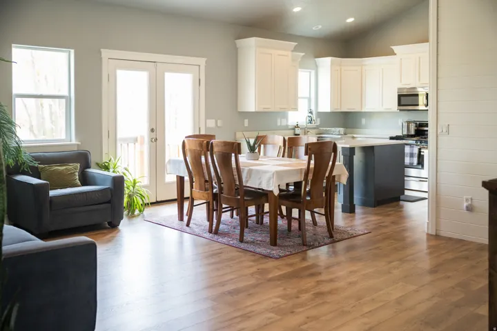 Dining room with french doors, lofted ceiling, dark wood-style floors, and recessed lighting