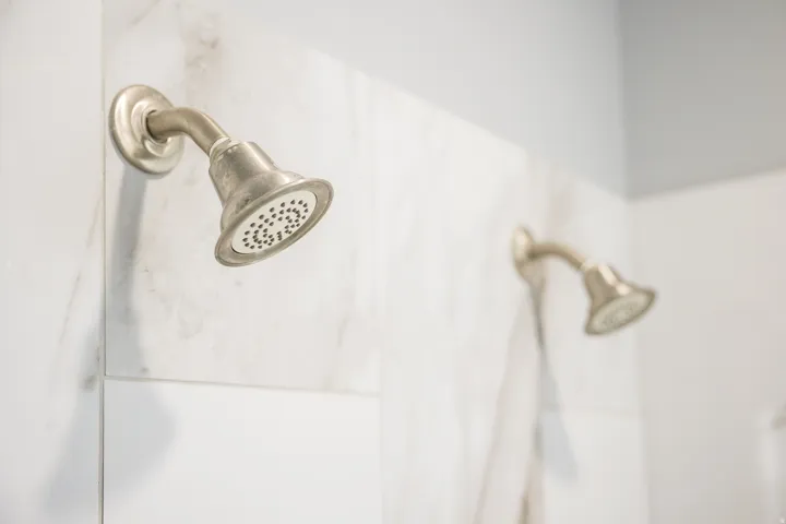 Bathroom view of a marble finish shower and a sink