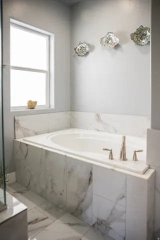 Full bath featuring tiled tub