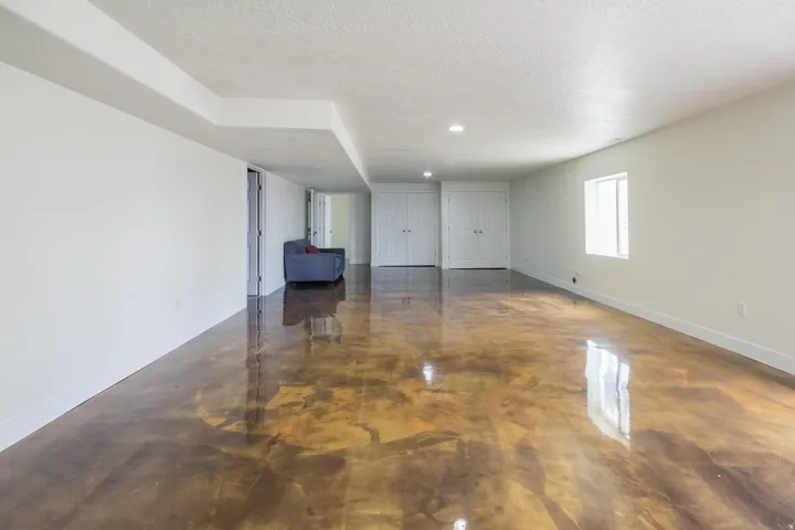 Unfurnished room featuring a textured ceiling, recessed lighting, and finished concrete floors
