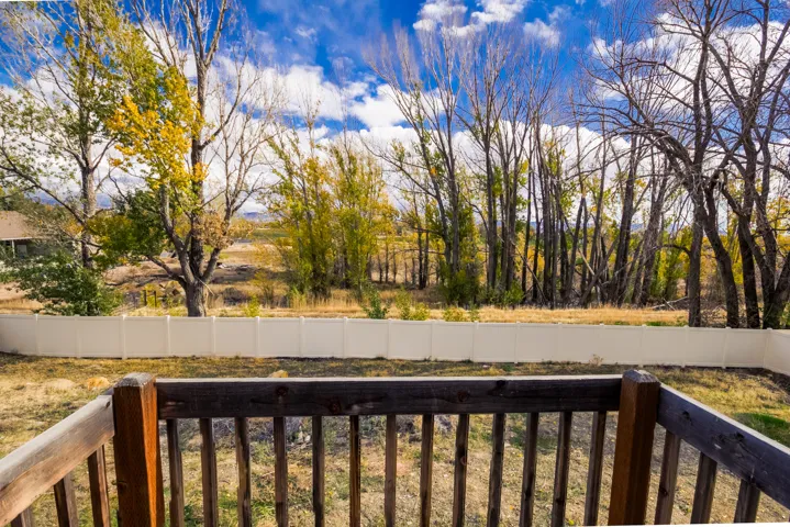 Wooden deck with a fenced backyard
