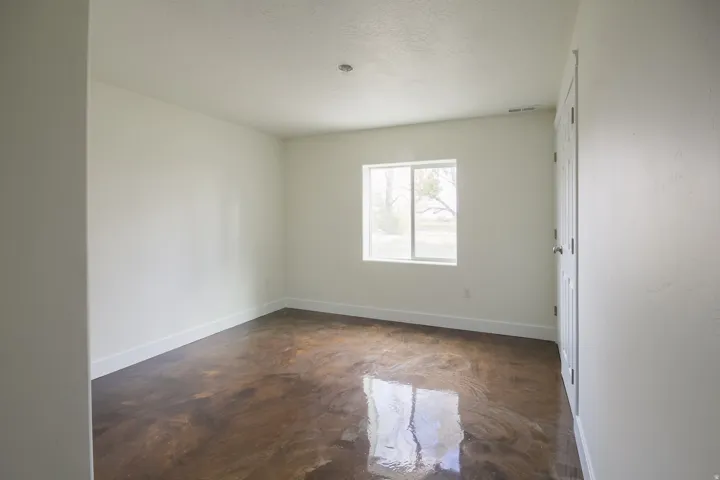 Empty room featuring finished concrete floors and a textured ceiling