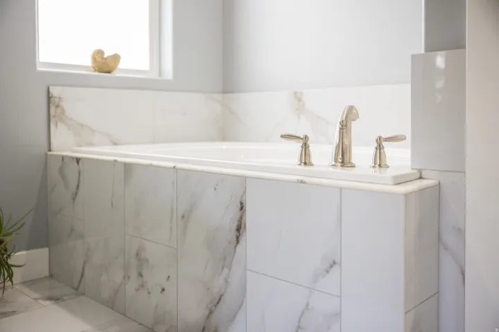 Full bath with marble finish floors