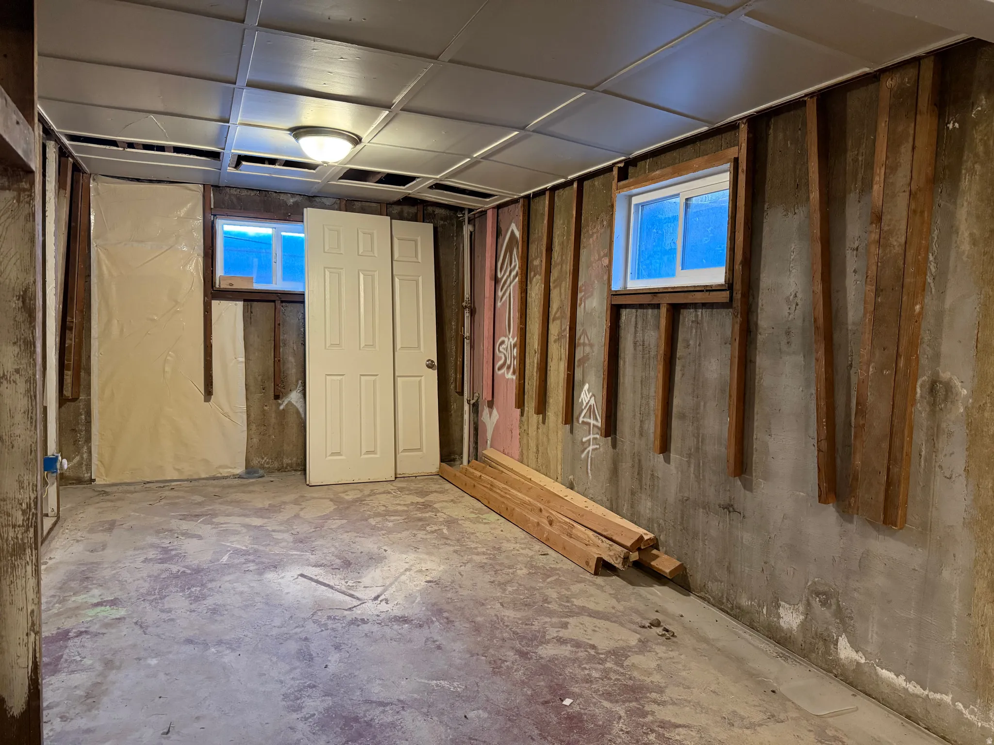 Unfinished basement bedroom  with panel ceiling