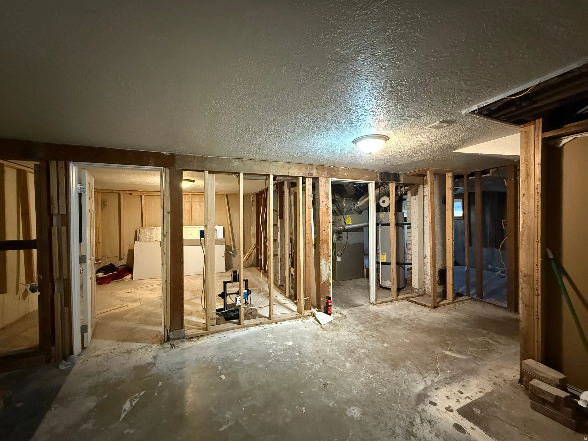 Miscellaneous room featuring a textured ceiling and heating unit