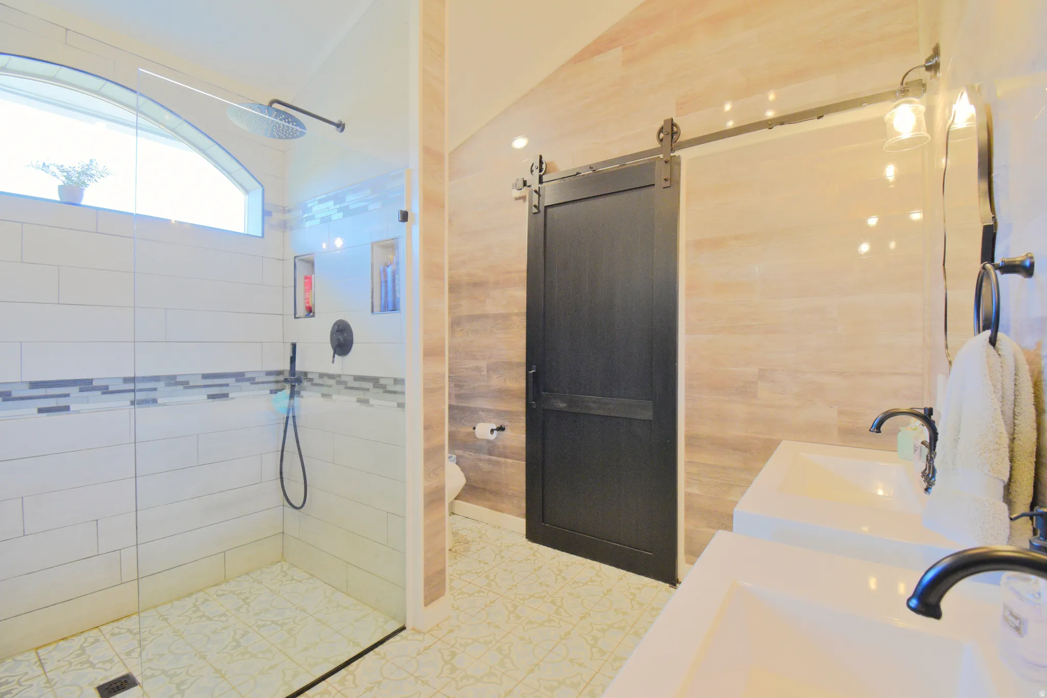 Bathroom featuring double vanity and walk in shower