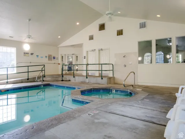 Indoor community pool featuring a ceiling fan
