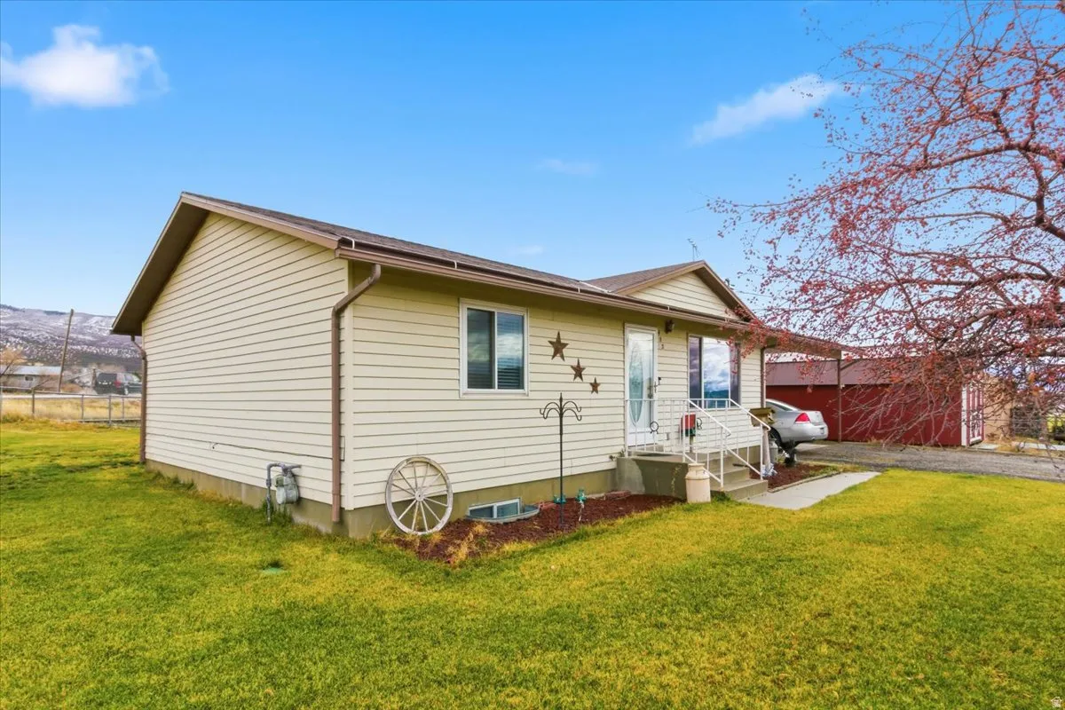 Back of property with a yard