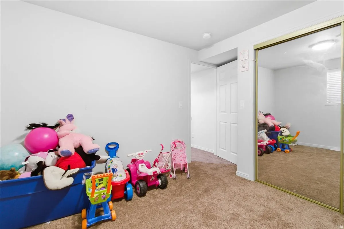 Recreation room with carpet and baseboards