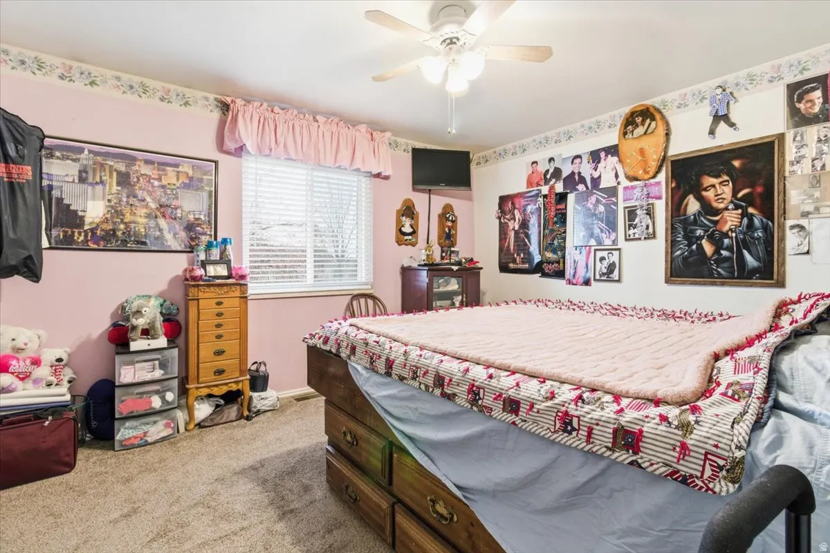 Bedroom featuring light colored carpet and ceiling fan