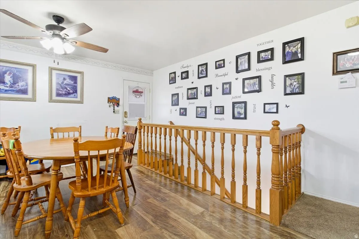 Dining area with wood finished floors and ceiling fan