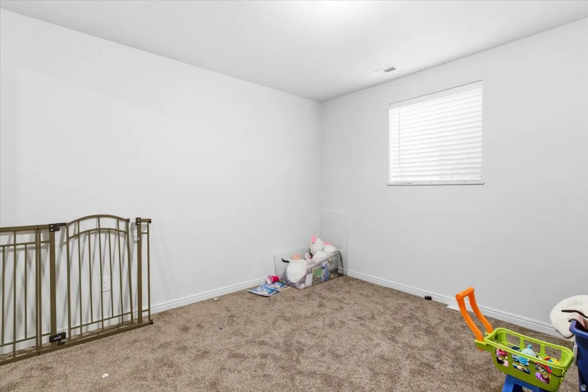 Unfurnished bedroom featuring carpet and baseboards