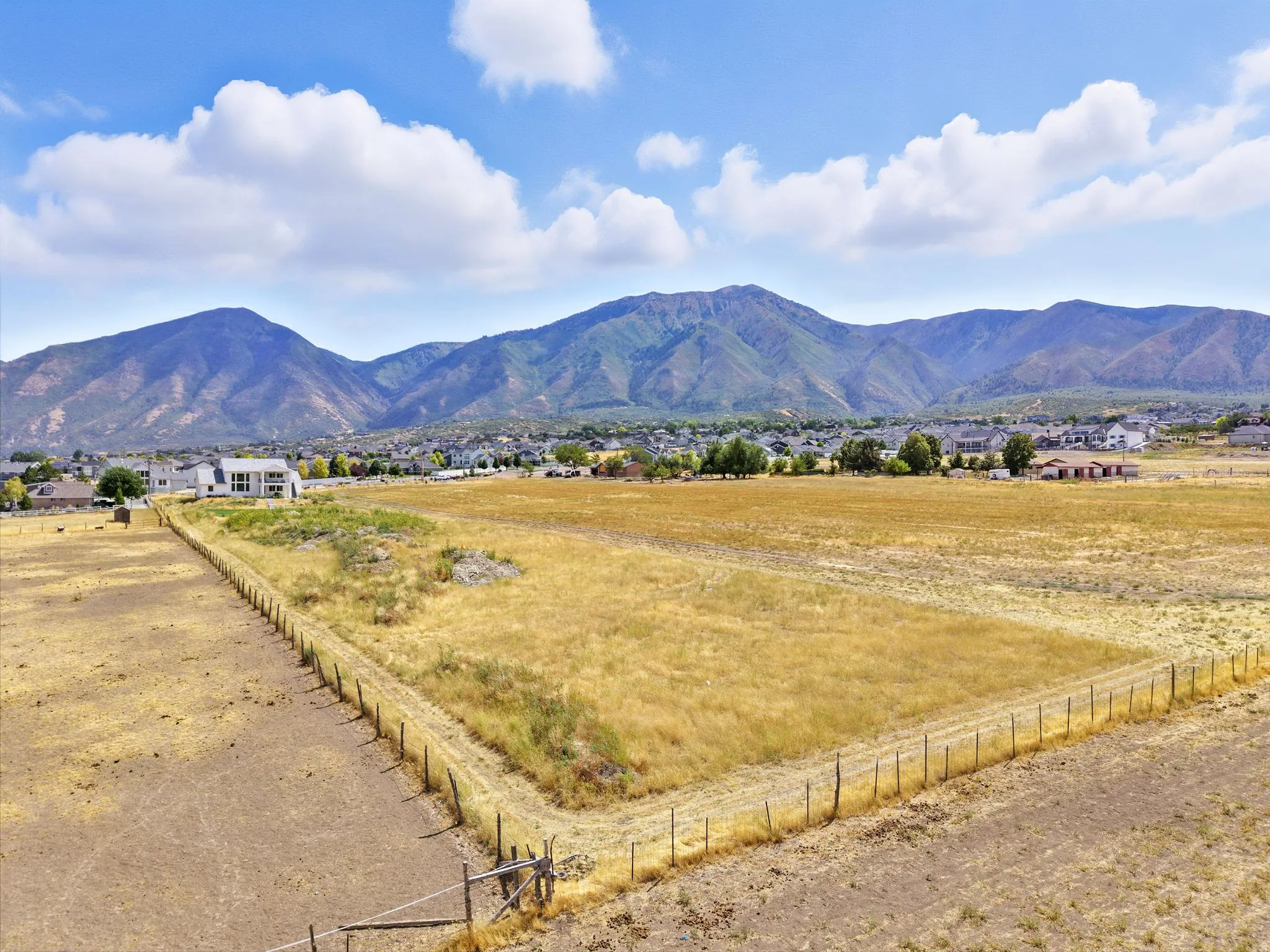 View from the back lot line looking at the home. Mountain views with rural landscape