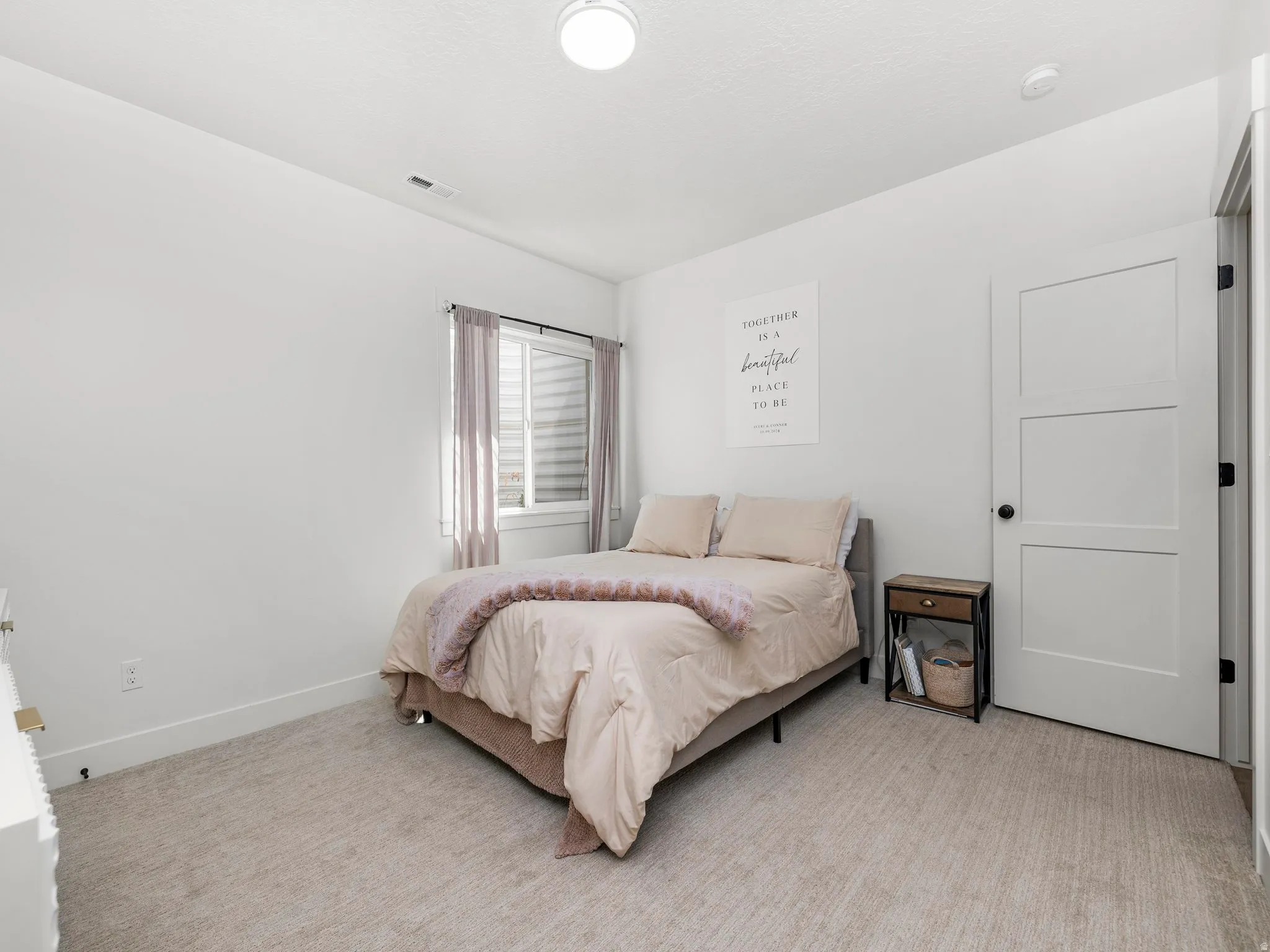 Basement apartment bedroom featuring carpet flooring and baseboards