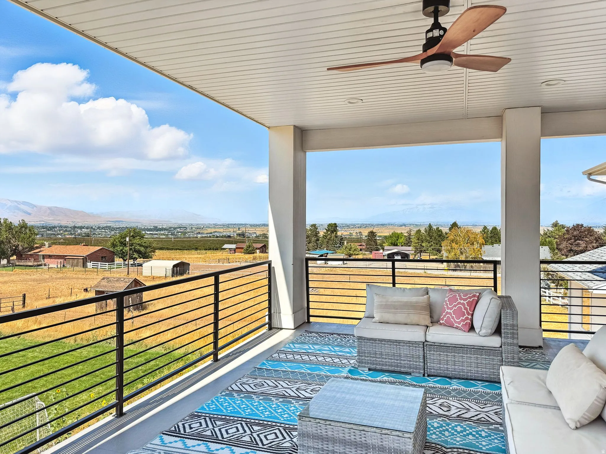 Upstairs covered deck right off of the HUGE loft. Ceiling fans, a mountain view, and an outdoor living space