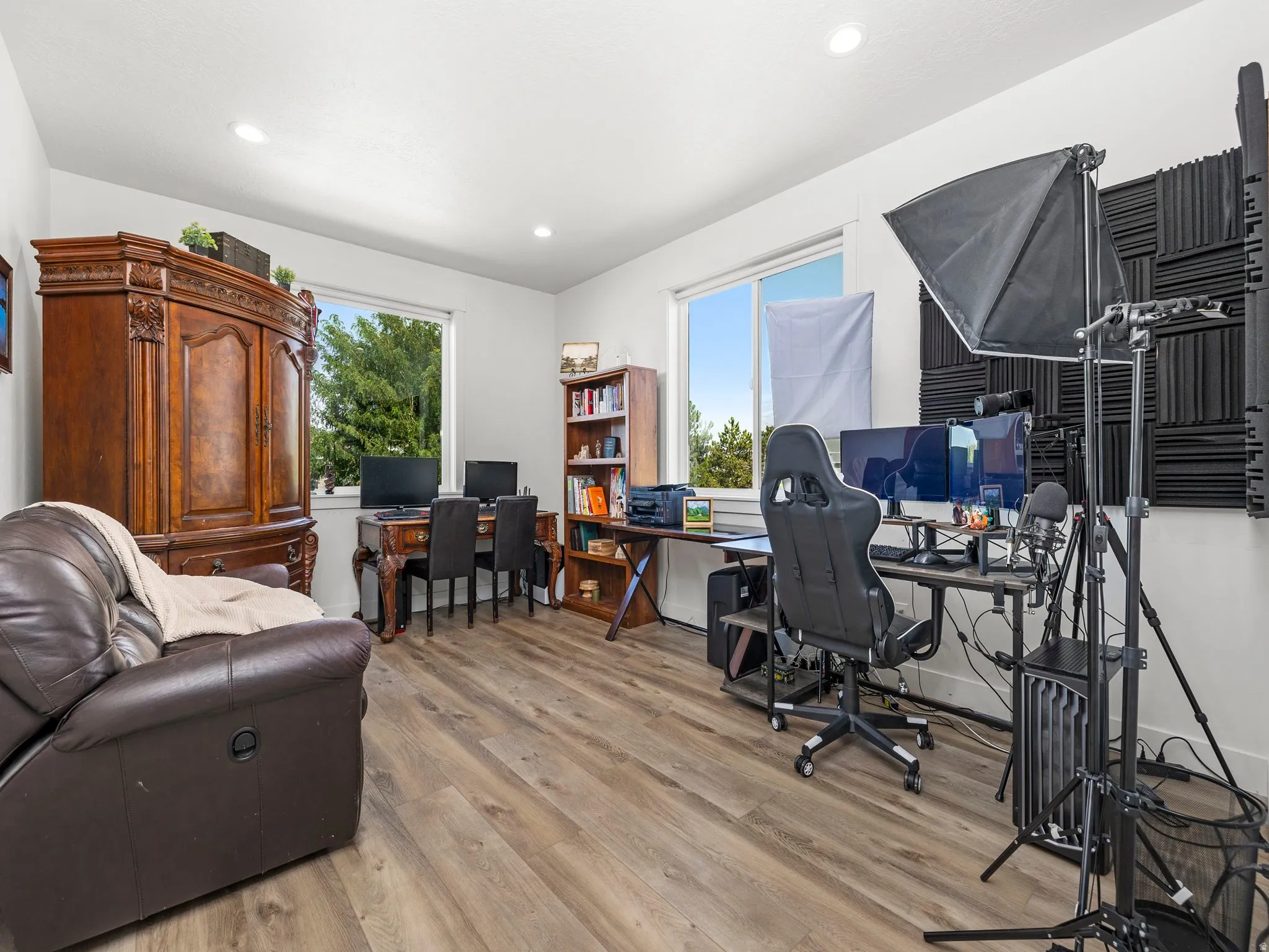 Office right off the front entry, with a second door into the owners suite; with light wood-style floors, plenty of natural light, and recessed lighting