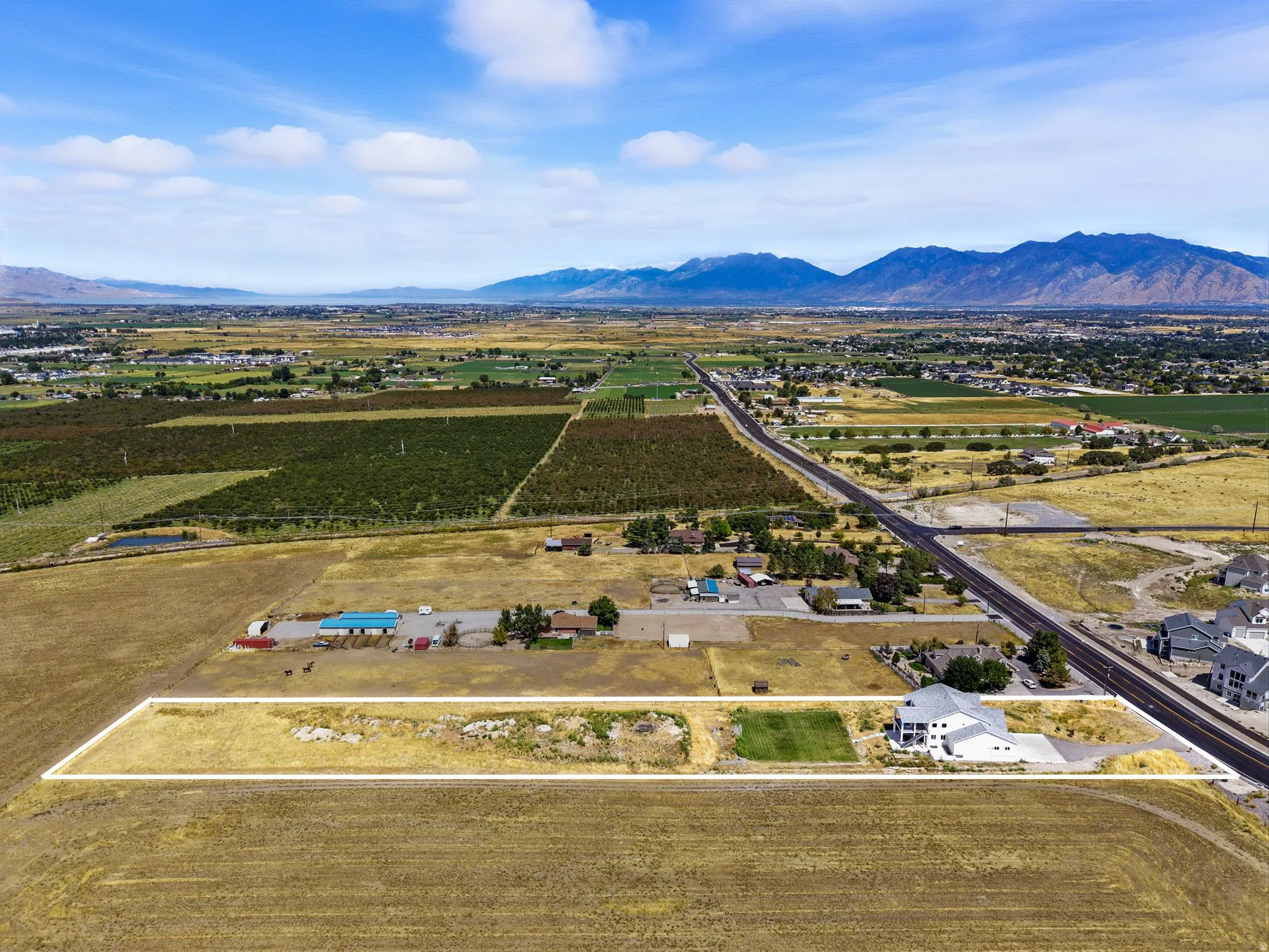 Overview of rural landscape featuring a mountainous background and farmland