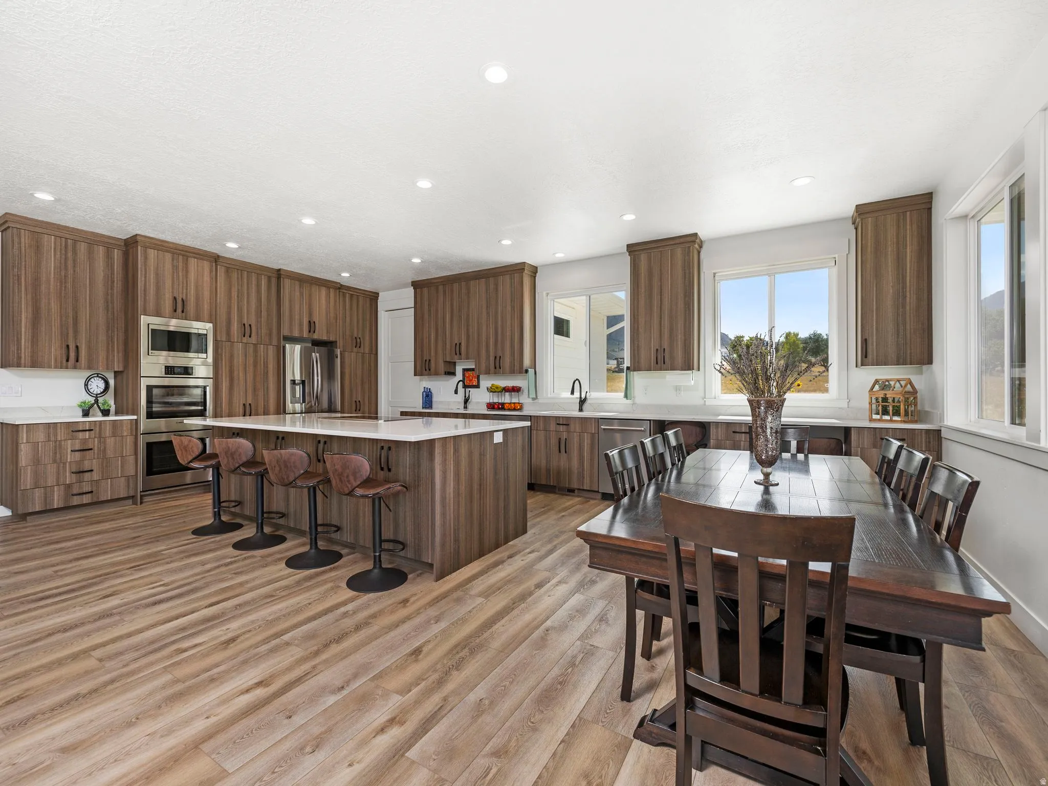 Dining space with light wood-style flooring and recessed led lighting