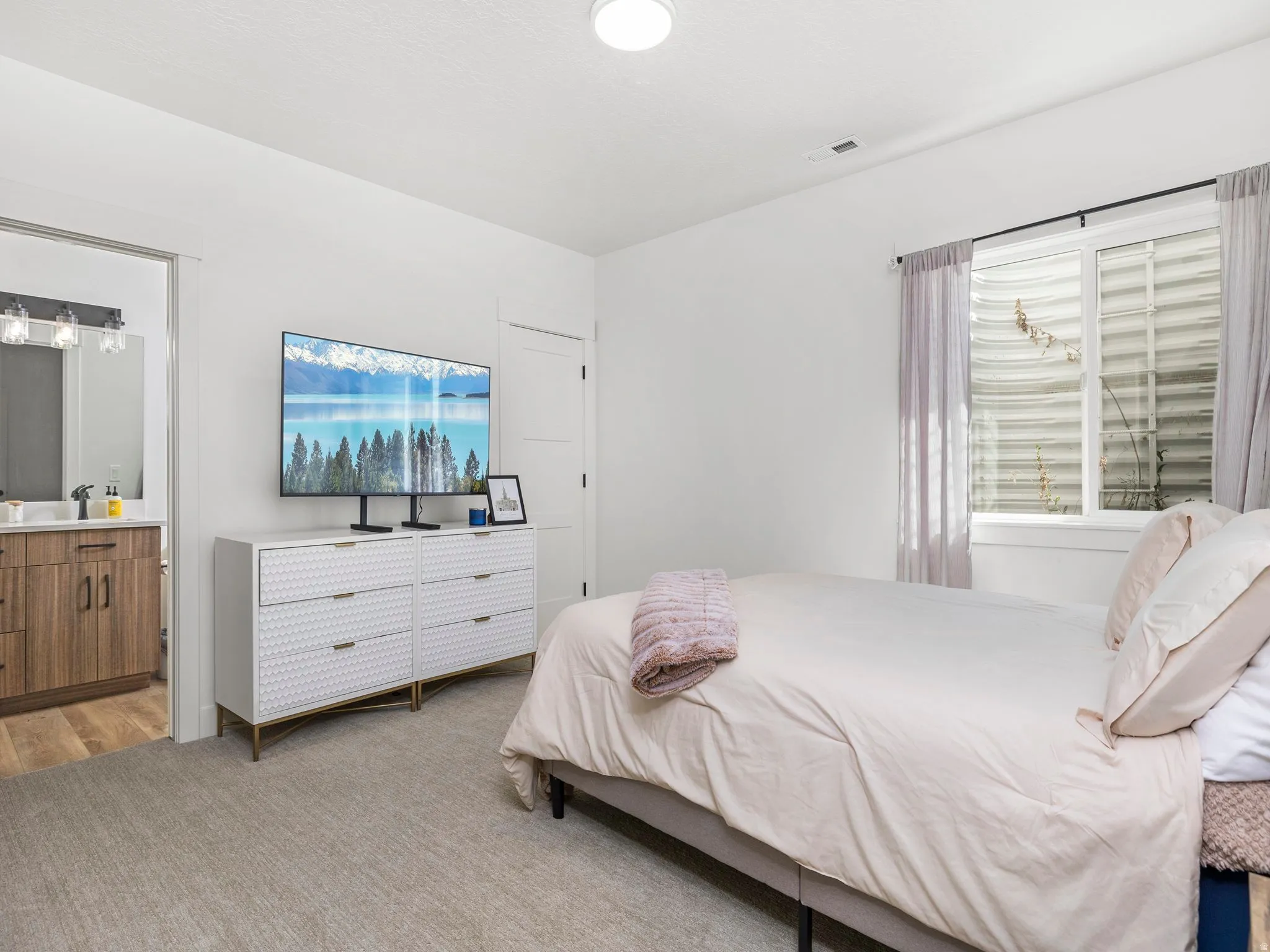 Basement apartment bedroom featuring carpet and ensuite bath