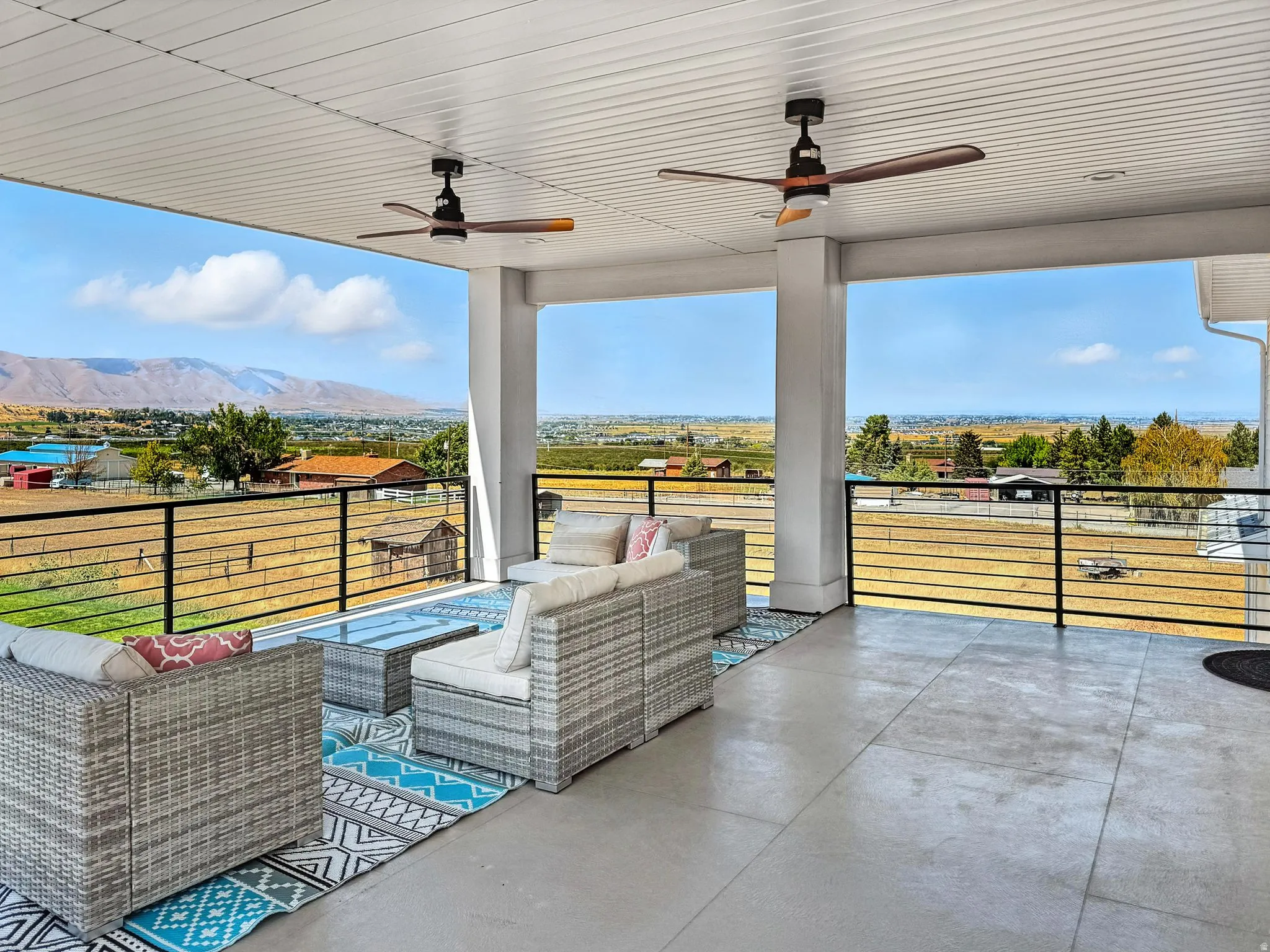 Upstairs covered deck right off of the HUGE loft. Ceiling fans, a mountain view, and an outdoor living space