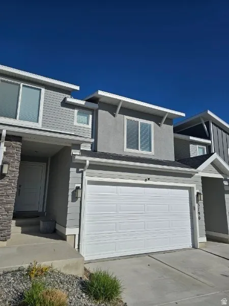 Traditional-style home with a garage and driveway