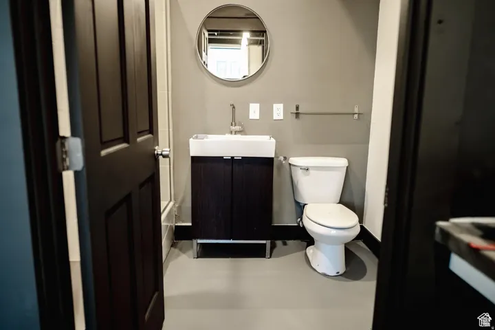Bathroom with vanity and finished concrete flooring