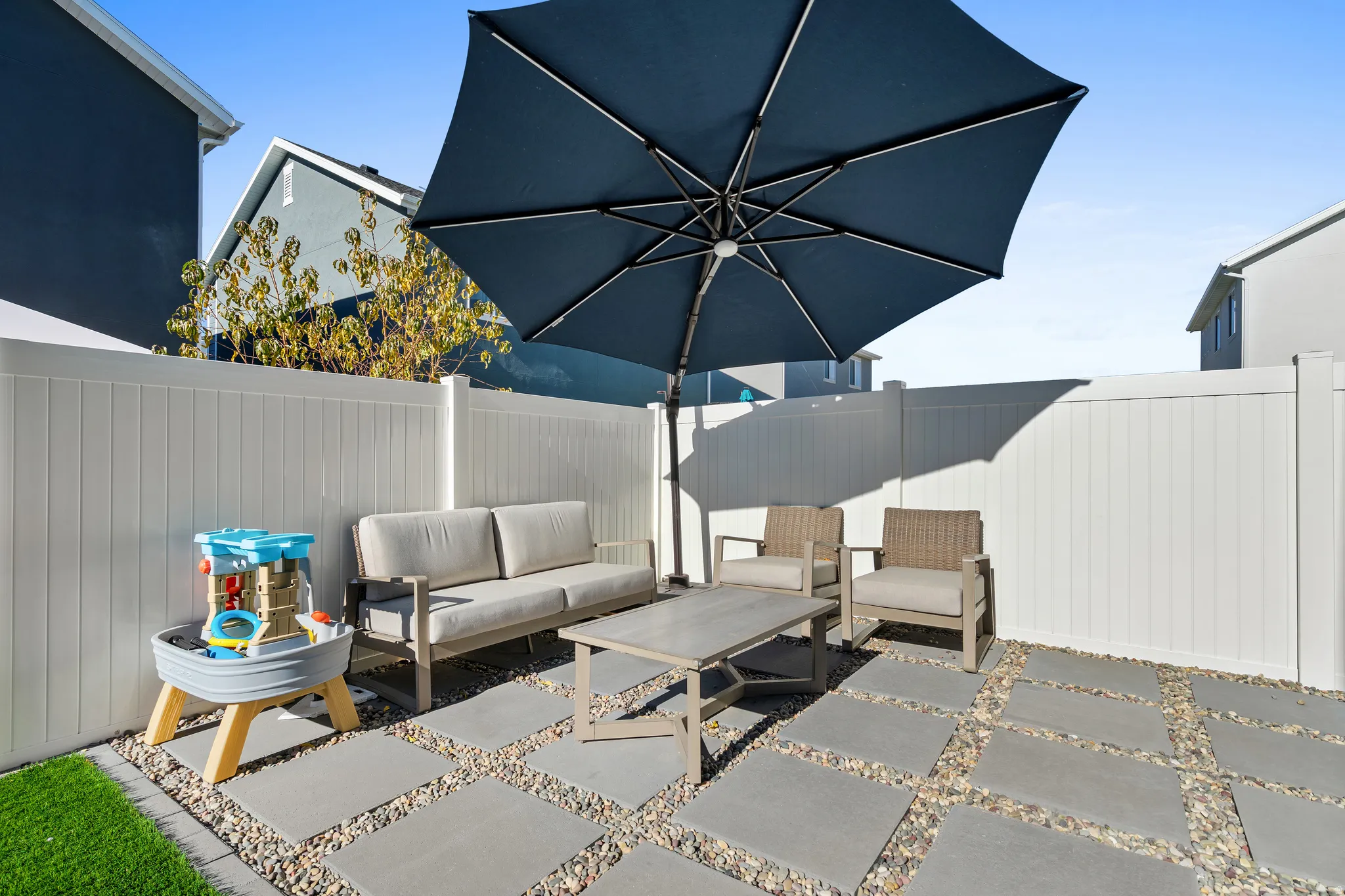 Fenced backyard with an outdoor hangout area and a patio