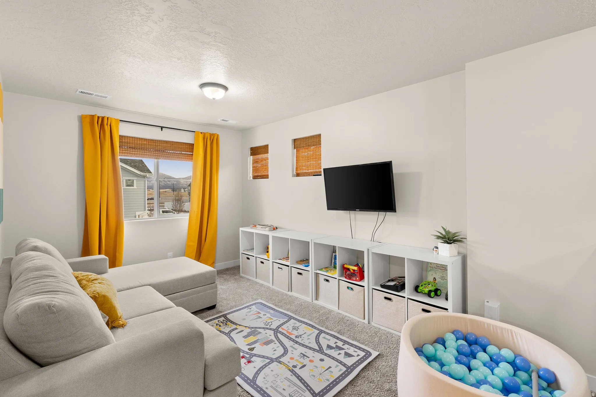 Living area featuring carpet floors and a textured ceiling
