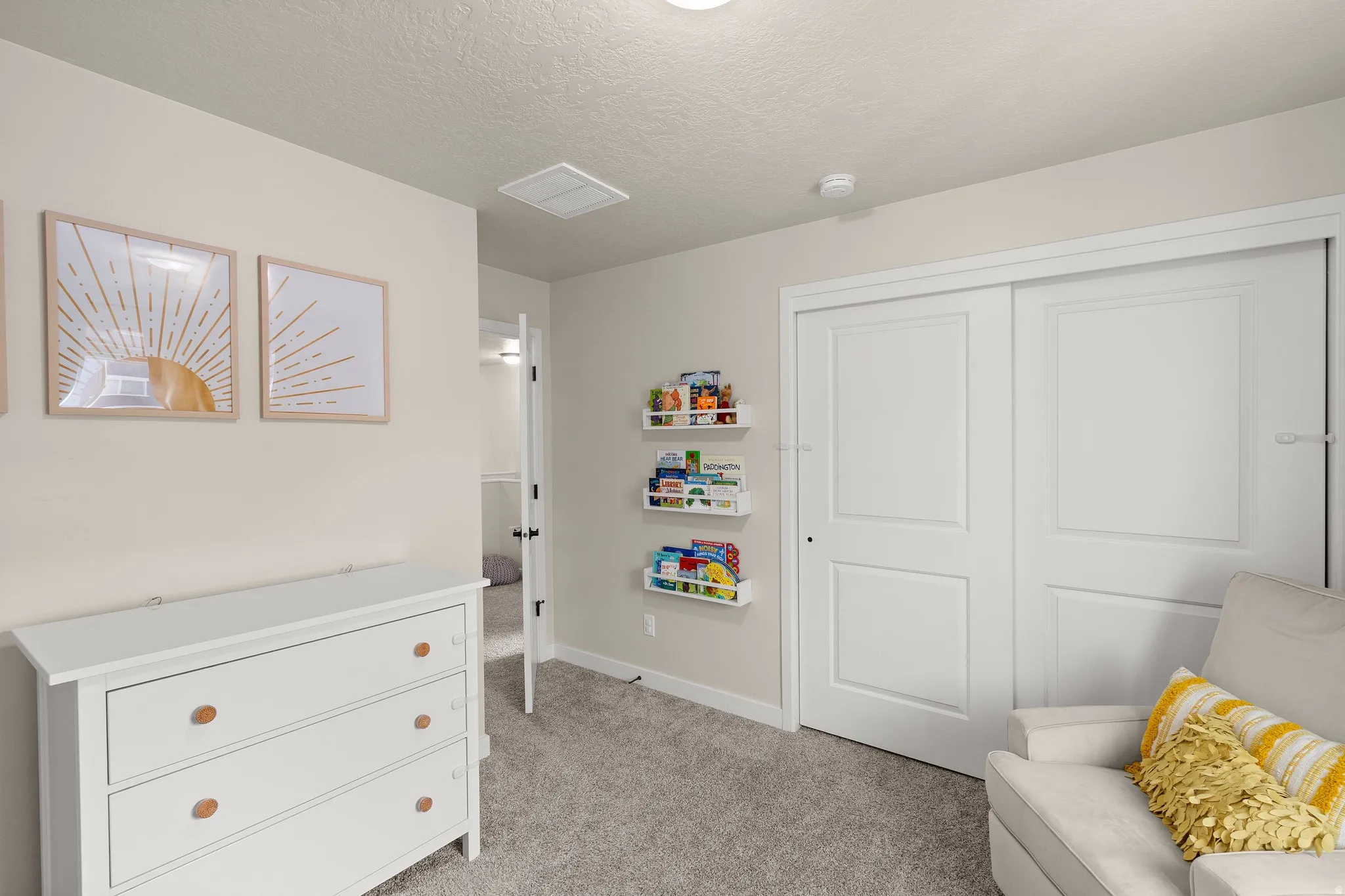 Sitting room with a textured ceiling and light colored carpet