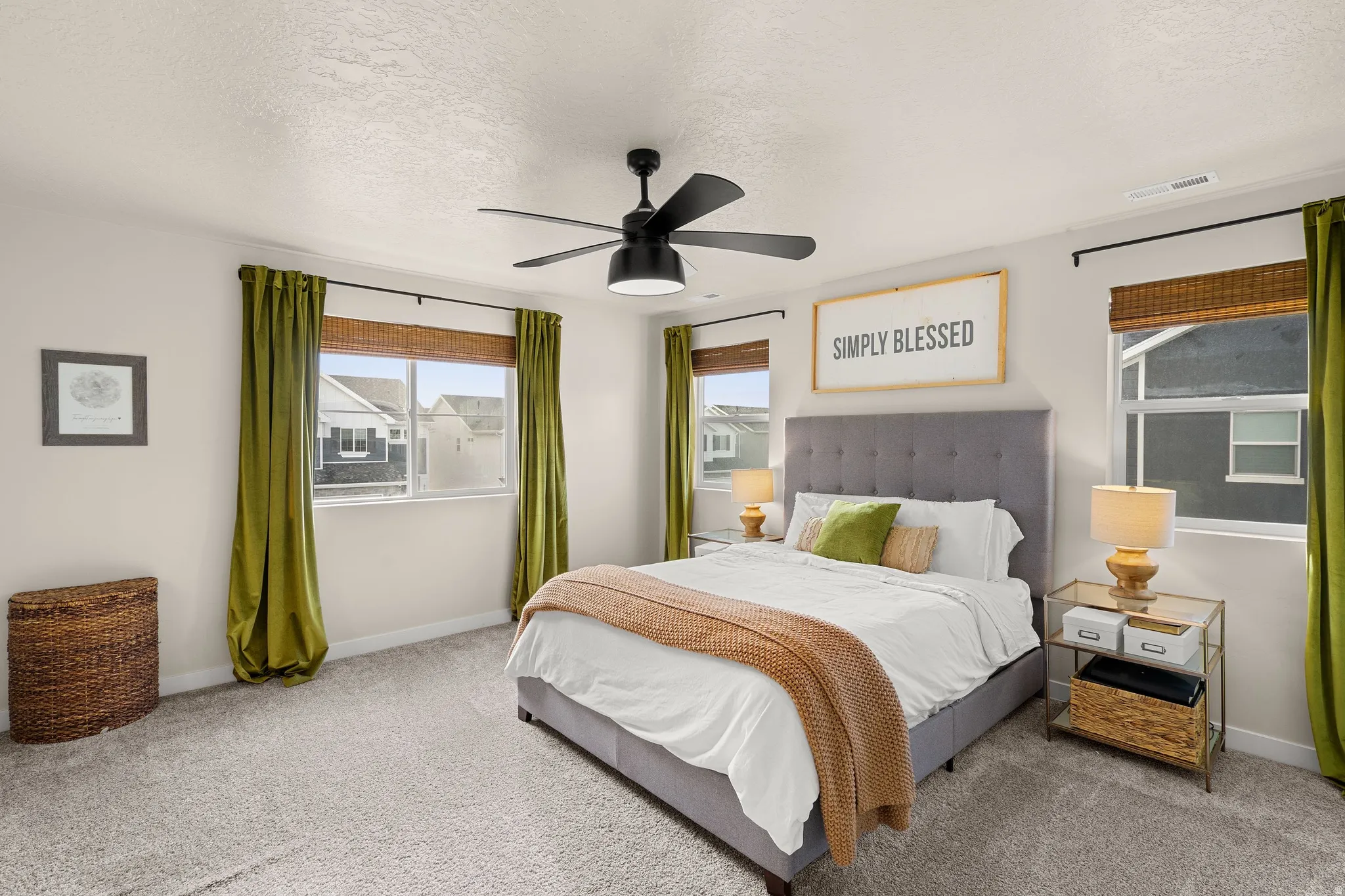 Bedroom with a textured ceiling, a ceiling fan, and carpet