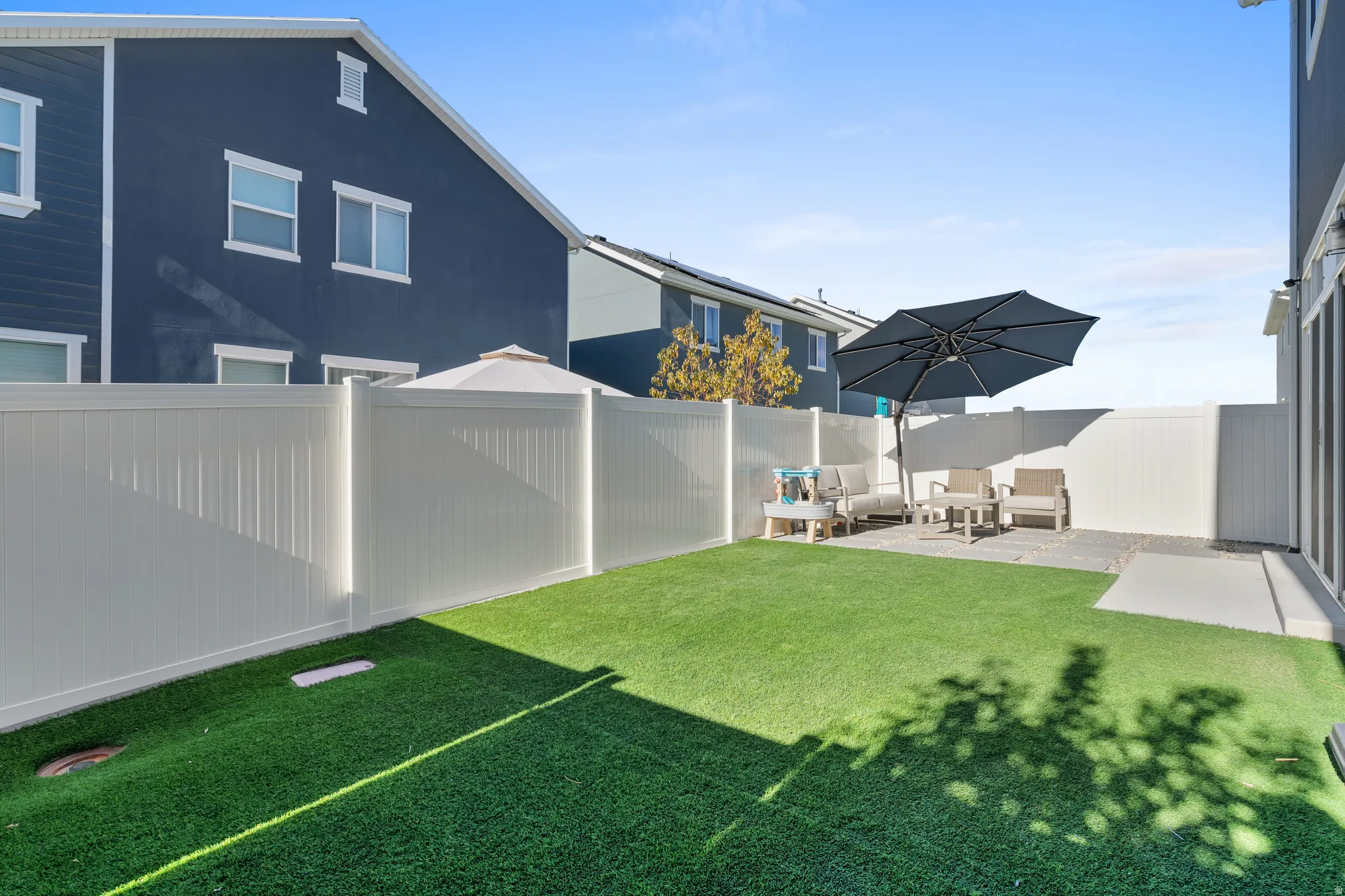 Fenced backyard featuring a patio