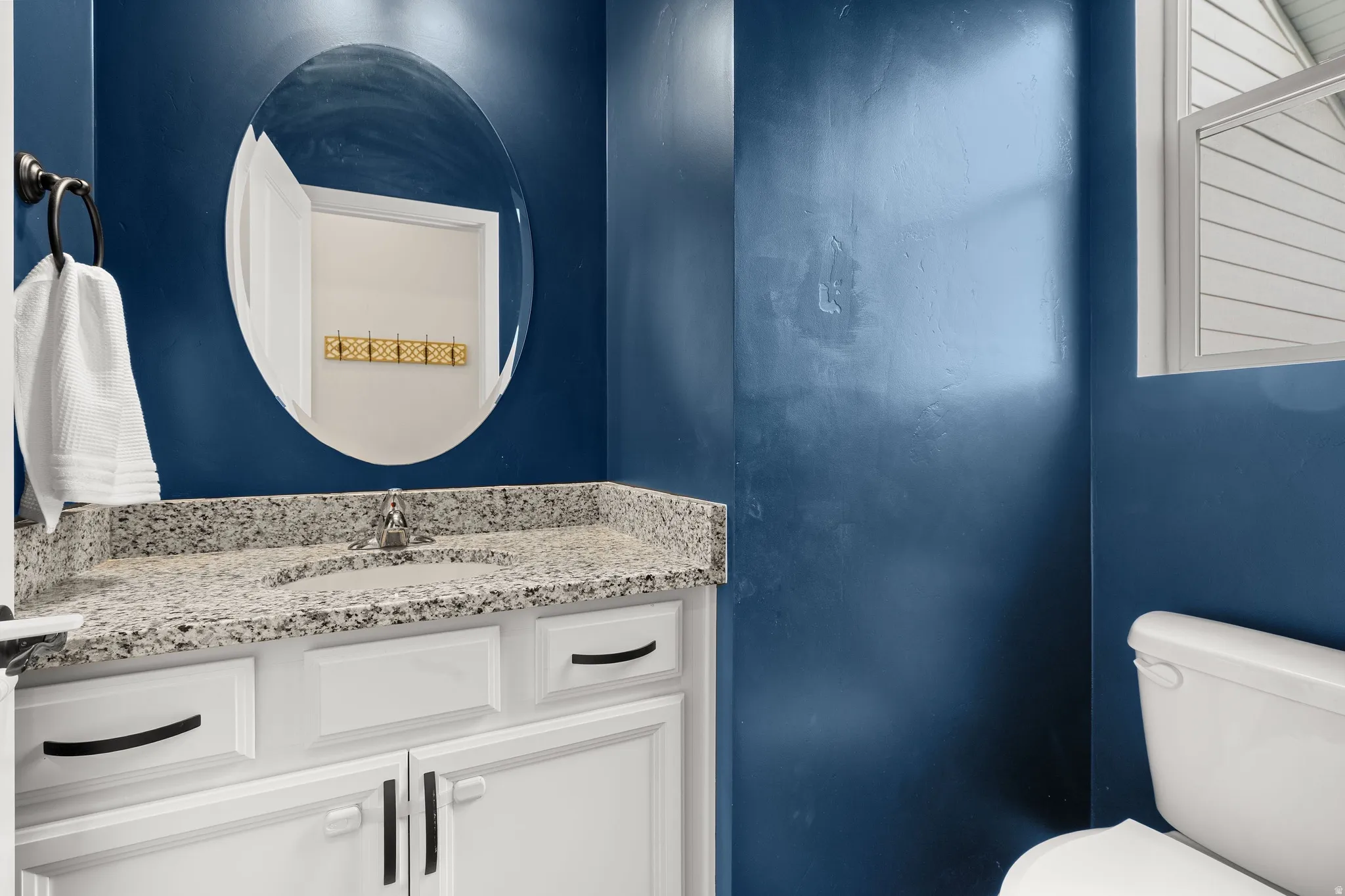 Half bath with vanity and toilet