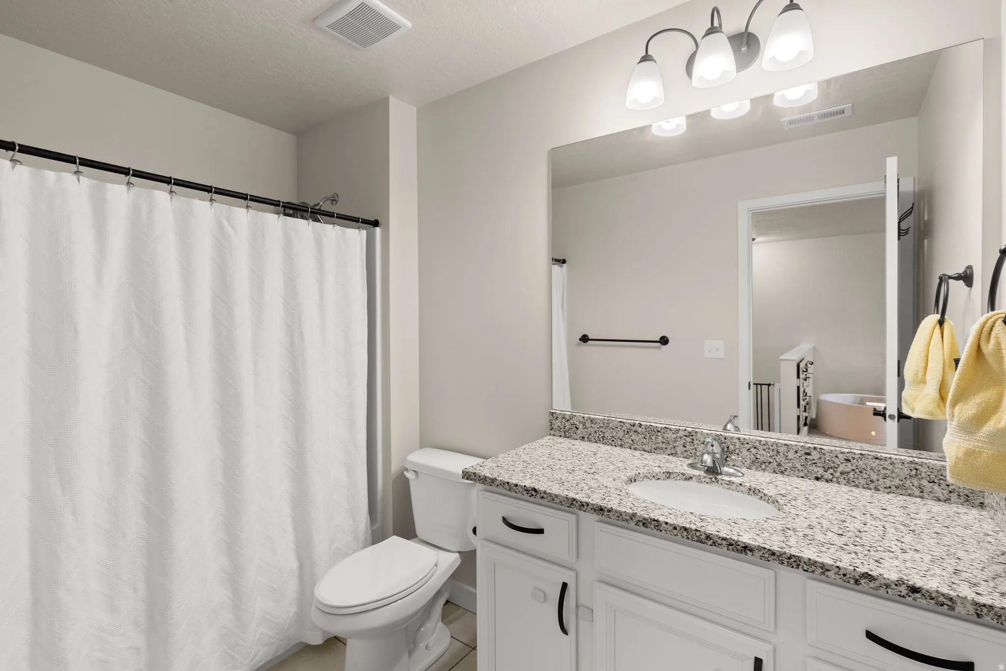 Full bath featuring vanity and a shower with shower curtain
