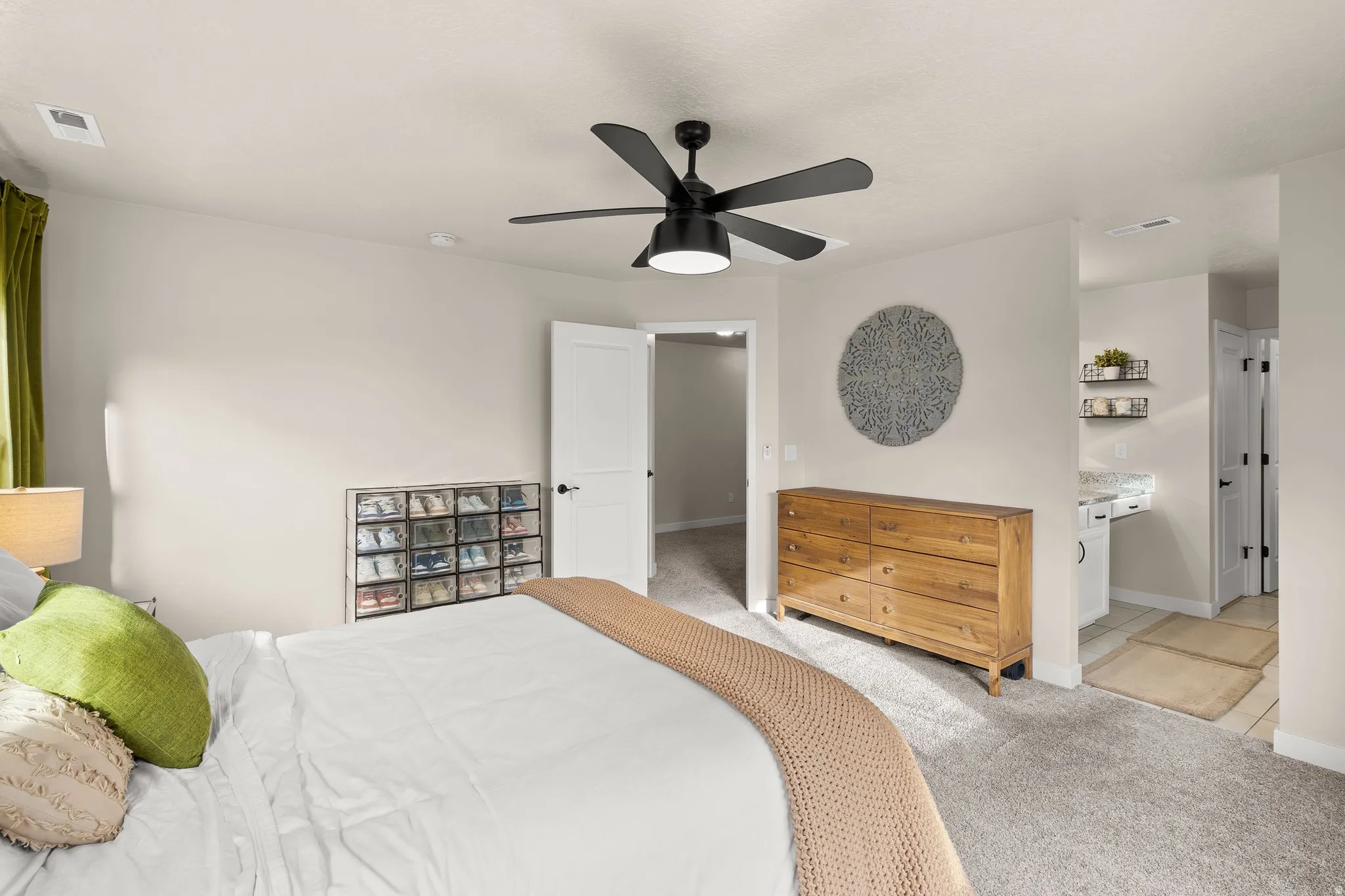 Bedroom featuring light carpet and ceiling fan