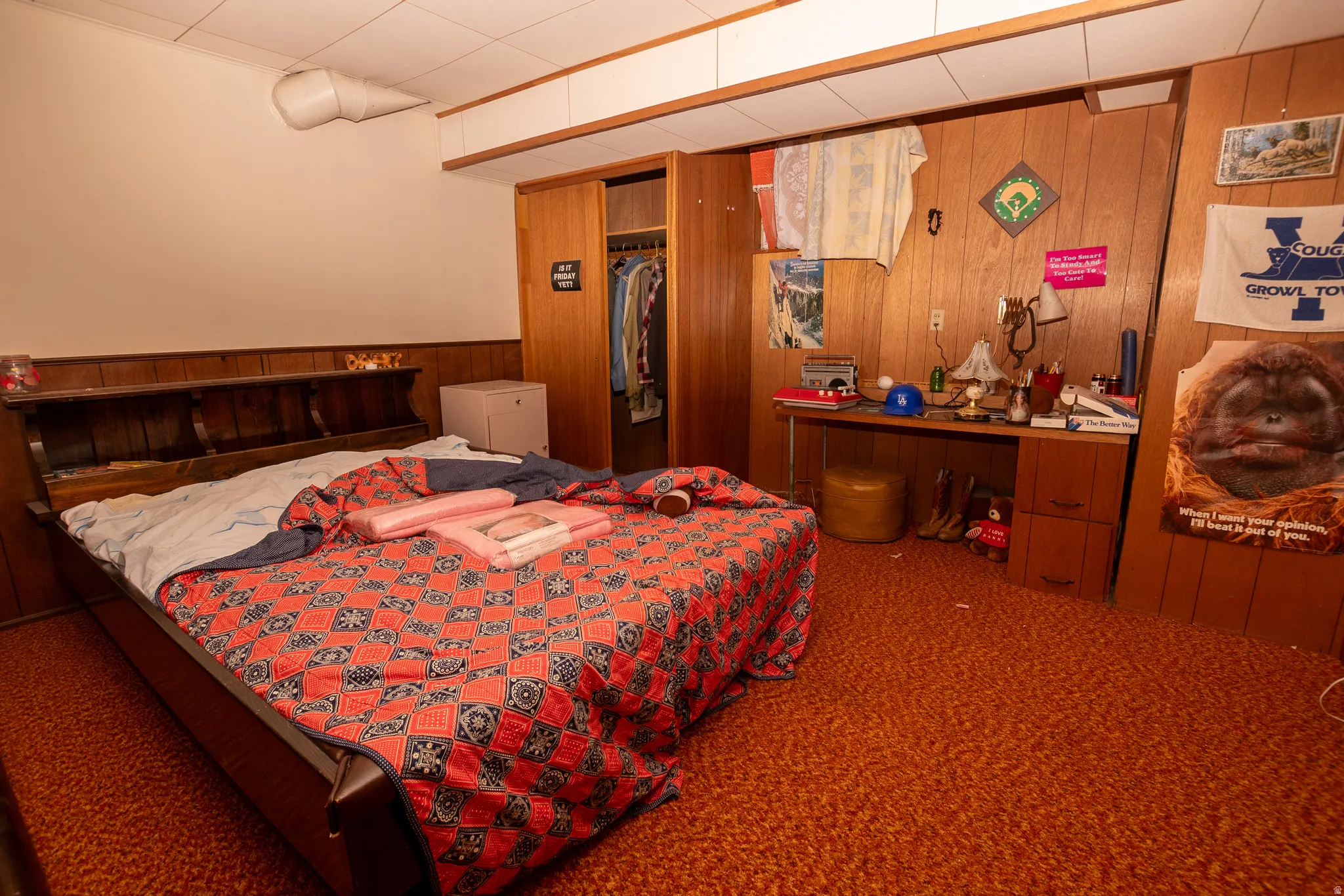 Bedroom with wooden walls and carpet
