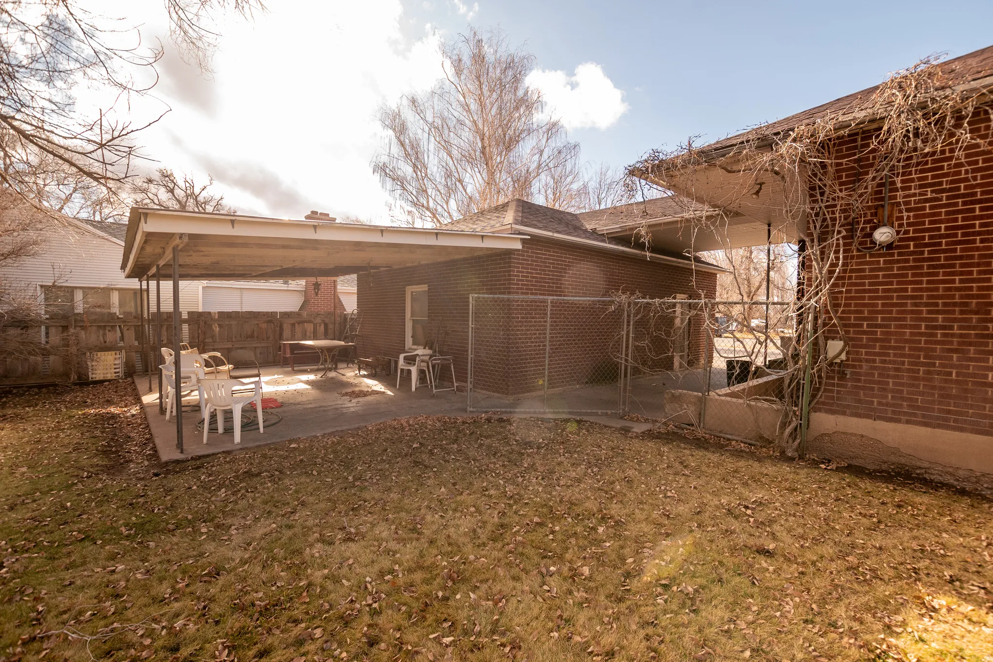 Rear view of property featuring a patio area and brick siding