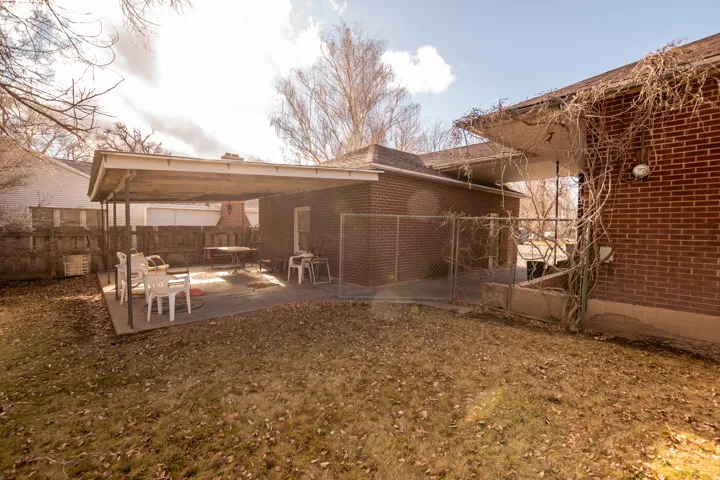 Rear view of property featuring a patio area and brick siding