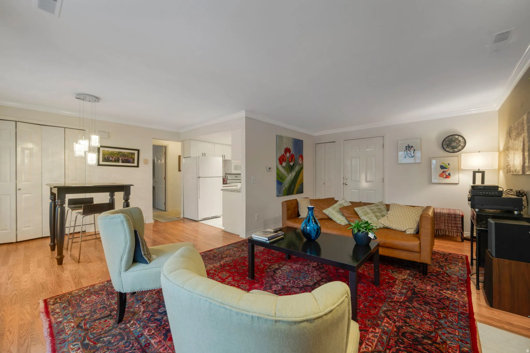 Living room featuring light wood-style floors and ornamental molding