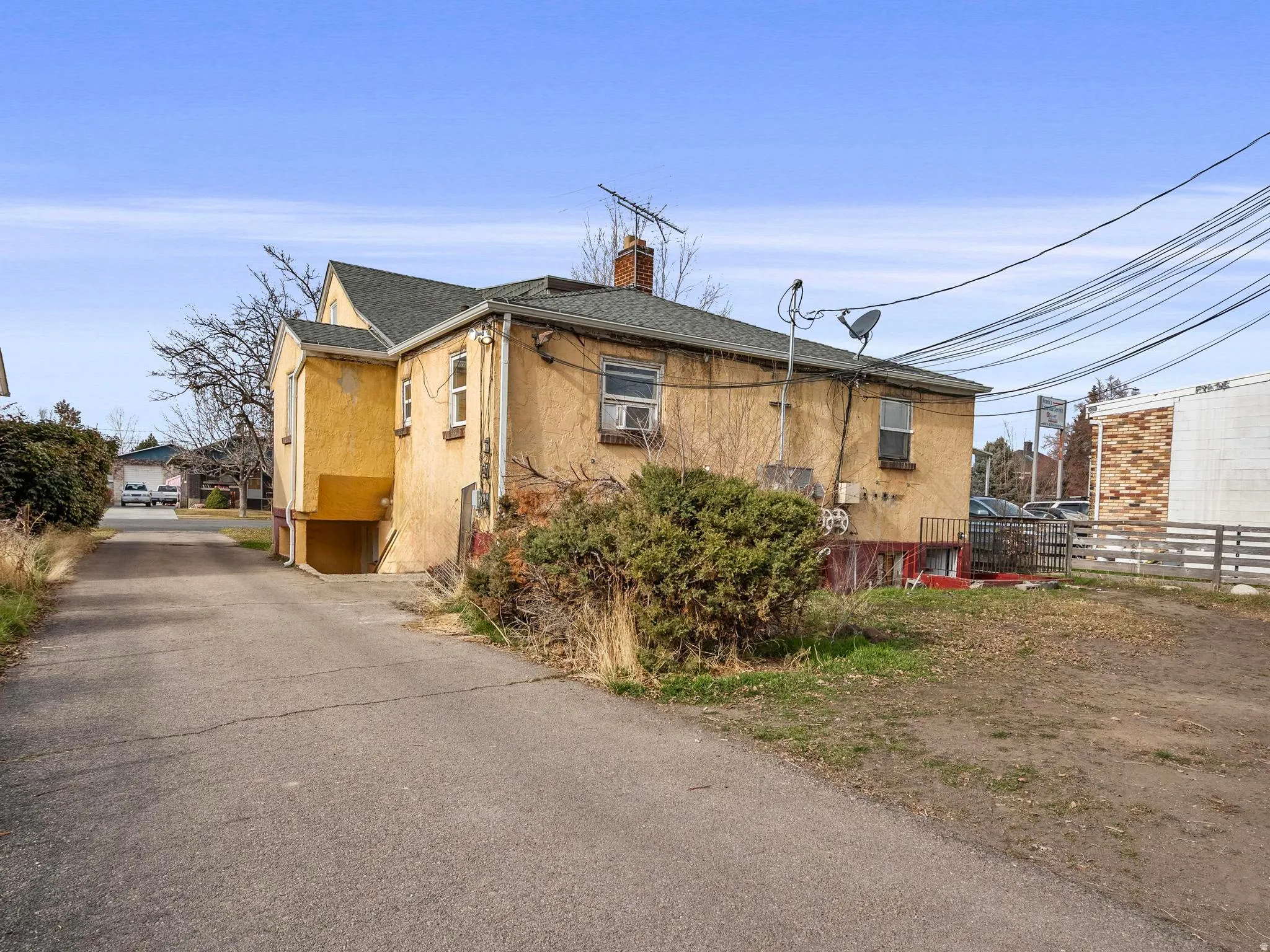 View private driveway to off street parking; view of rear of the property; left entrance is the 1 bedroom basement unit; right entrance is to the shared laundry and studio apartment