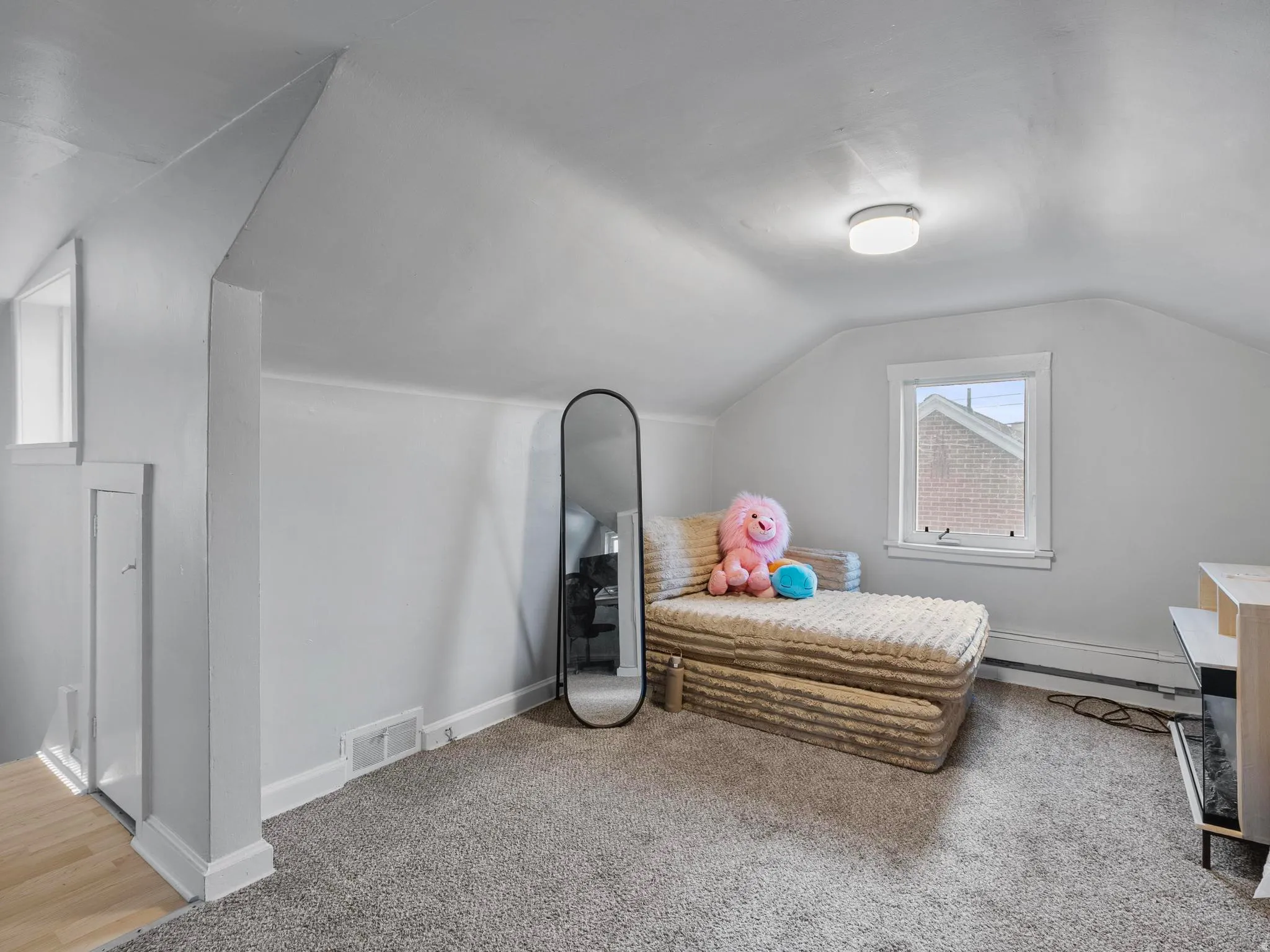 Bedroom featuring carpet, lofted ceiling, and a baseboard radiator