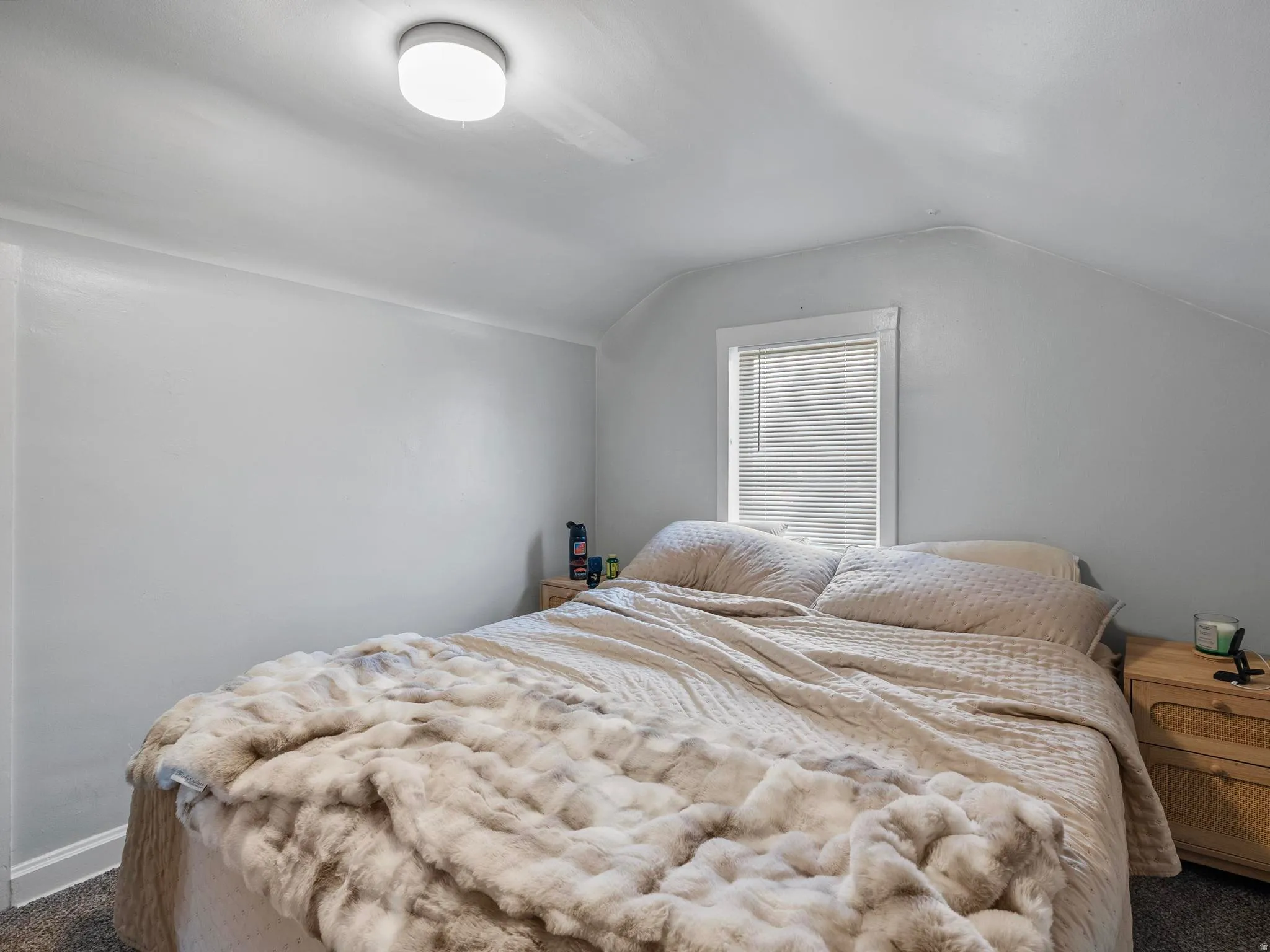 Carpeted bedroom with vaulted ceiling