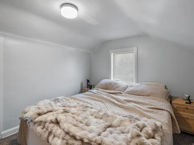 Carpeted bedroom with vaulted ceiling